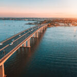 an aerial photo of traffic on Captain Cook bridge over Georges River.