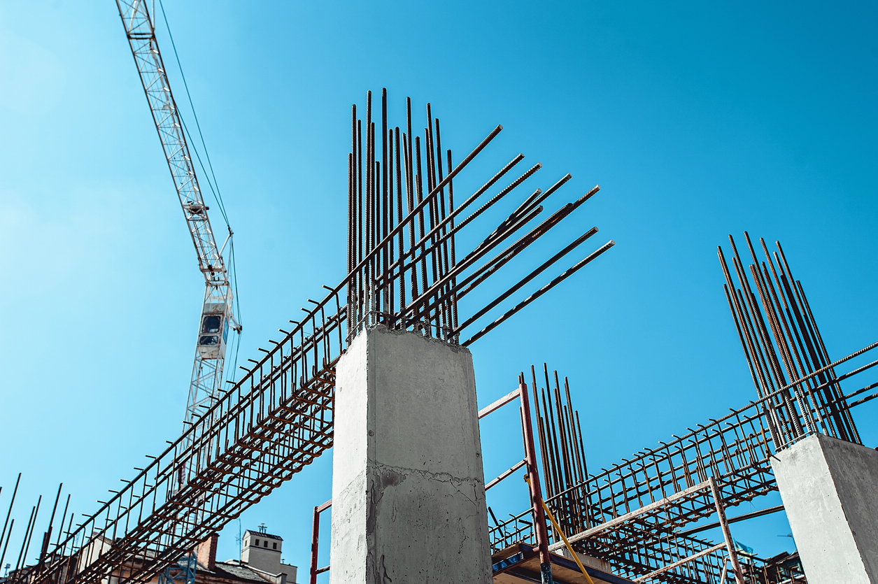 steel Frames of A Building Under Construction, With Tower Crane On Top.