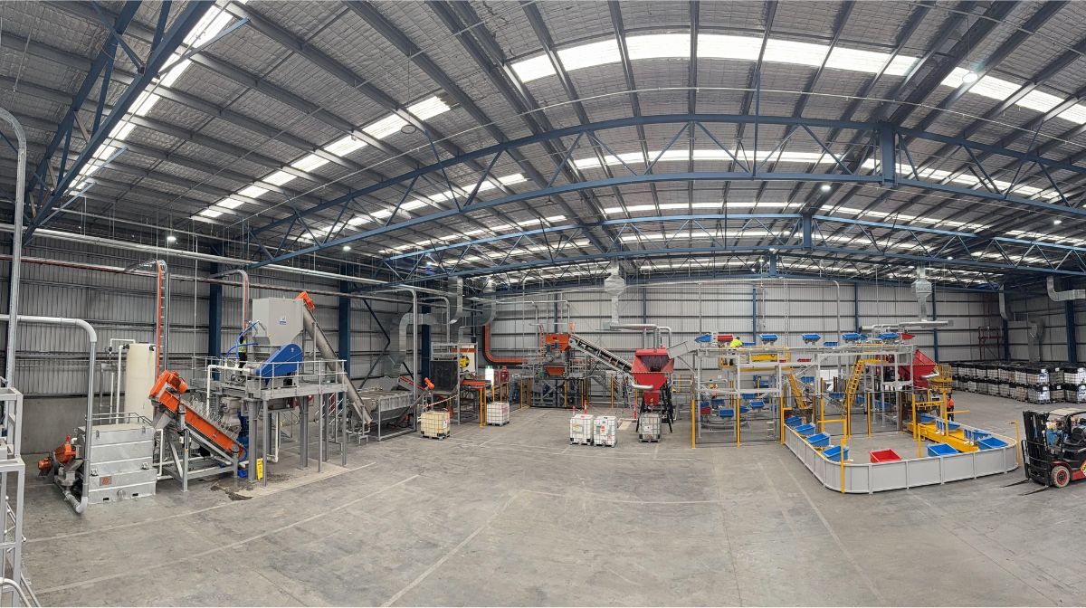 a wide angled photo of a warehouse with machinery for recycling waste paint